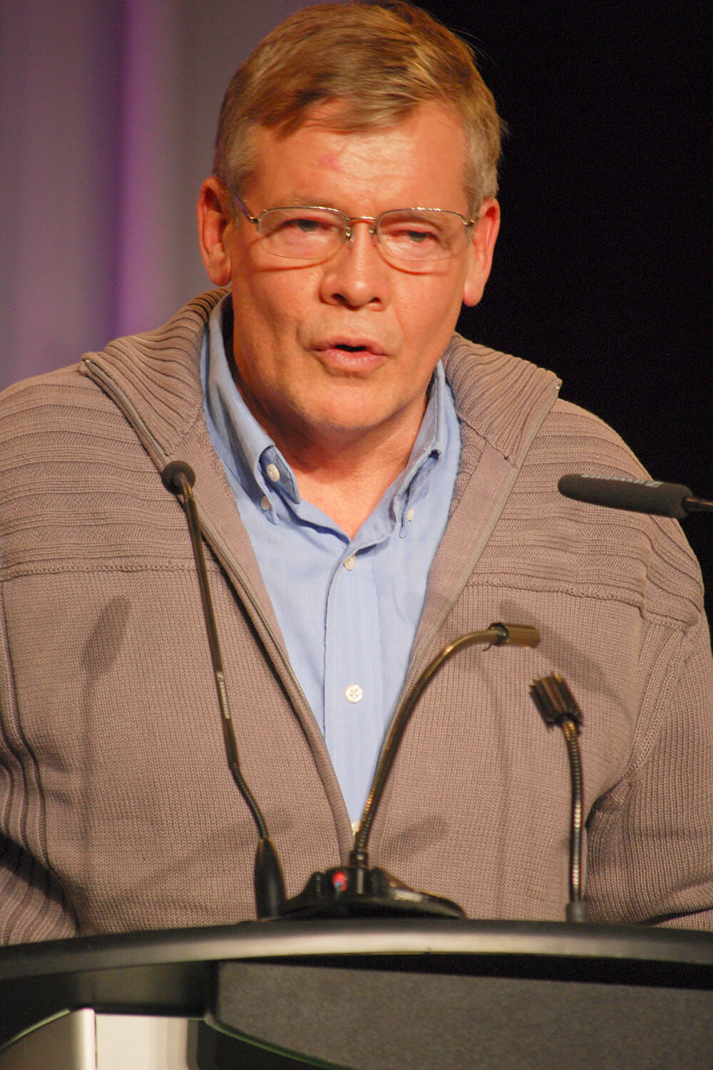 man speaking at a podium