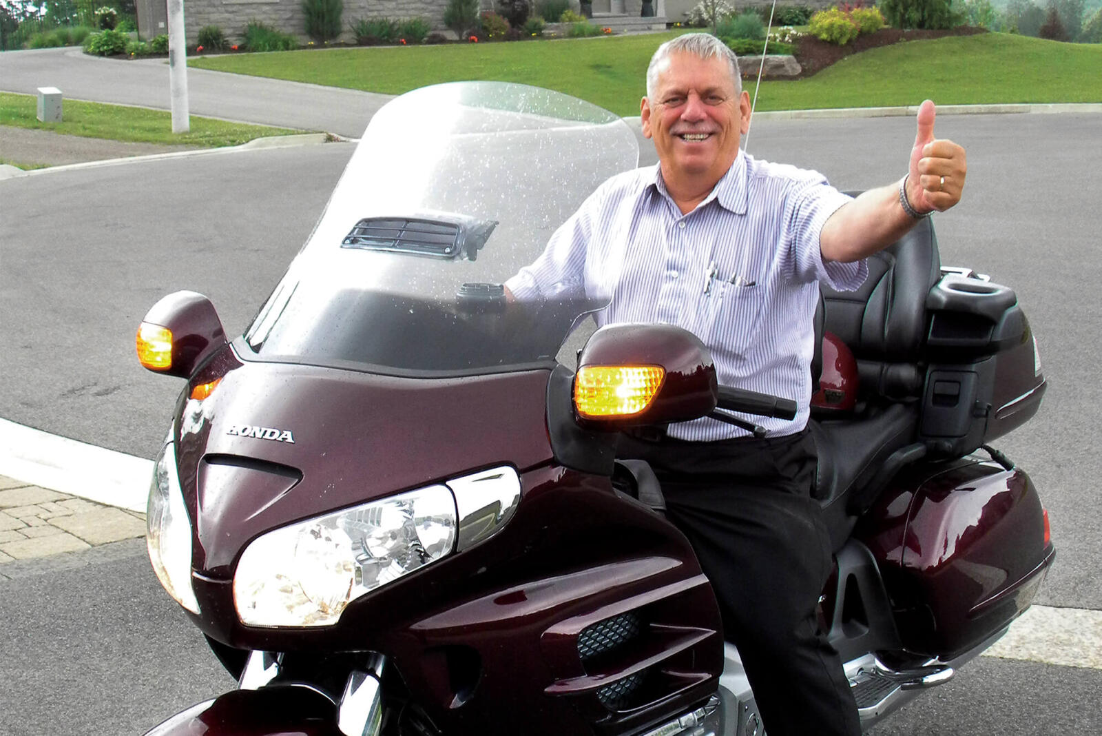 man on a motorcycle giving a thumbs up