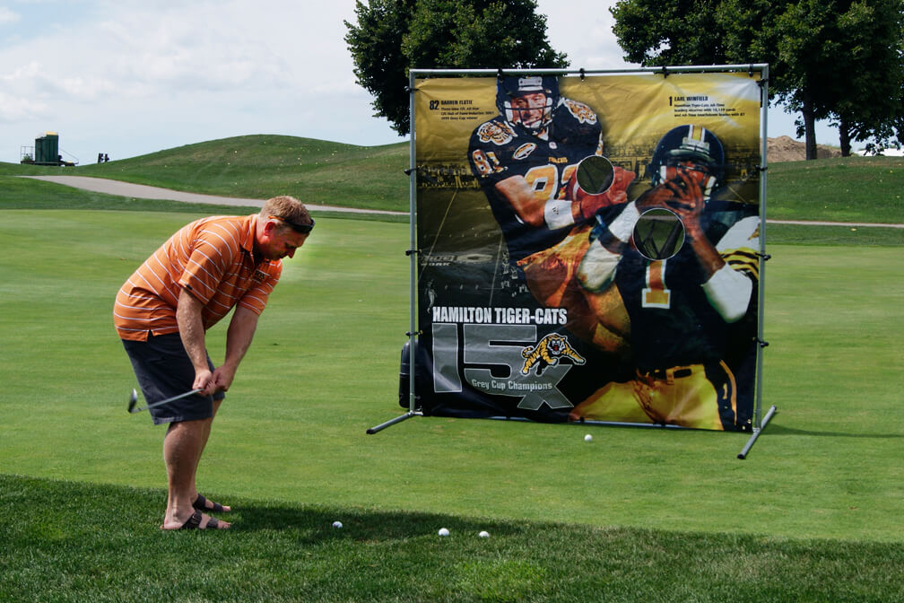 man chipping at a target