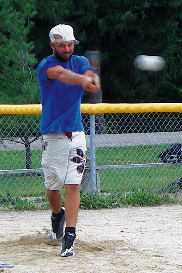 man hitting a baseball